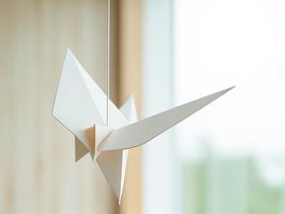 Mobile en origami suspendu dans un espace lumineux